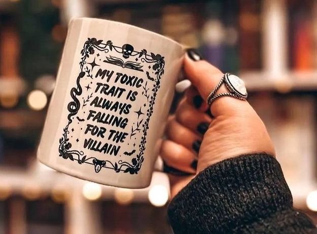 a photo of a mug that says "My toxic trait is always falling for the villain"