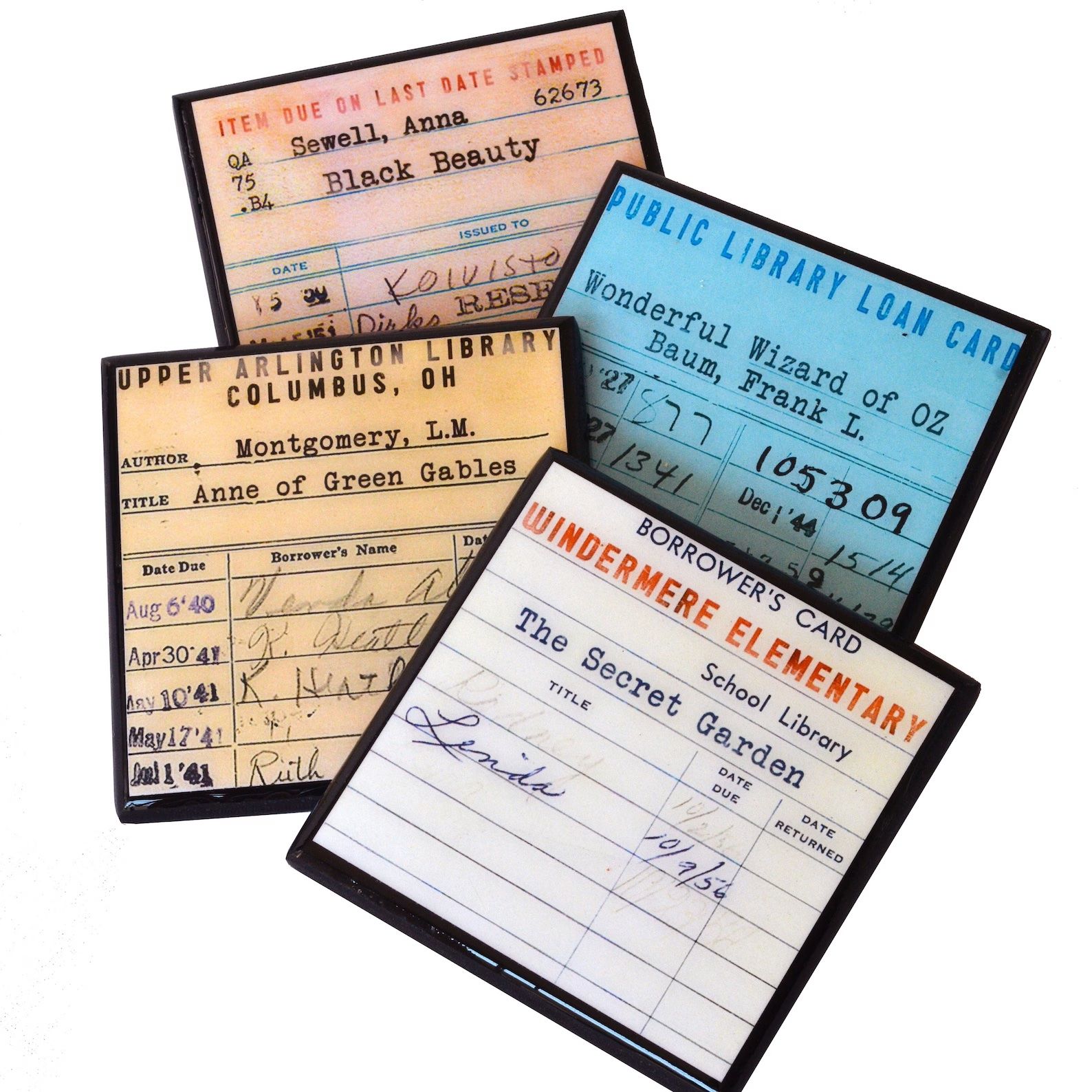 A pile of four library due date card printed coasters are on a white background.