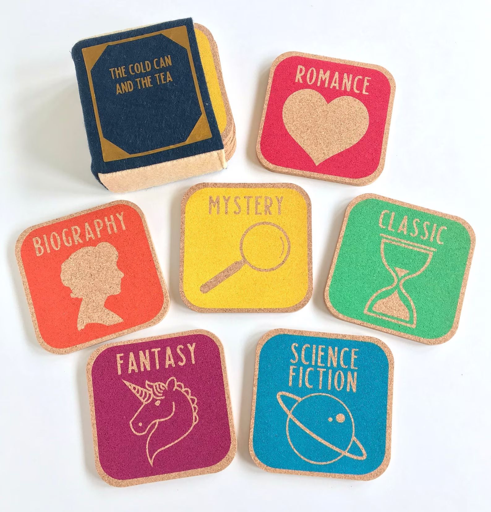 six cork library genre coasters are on a table next to a coaster holder.