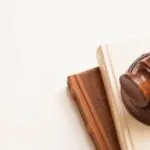 a brown gavel against a cream colored background