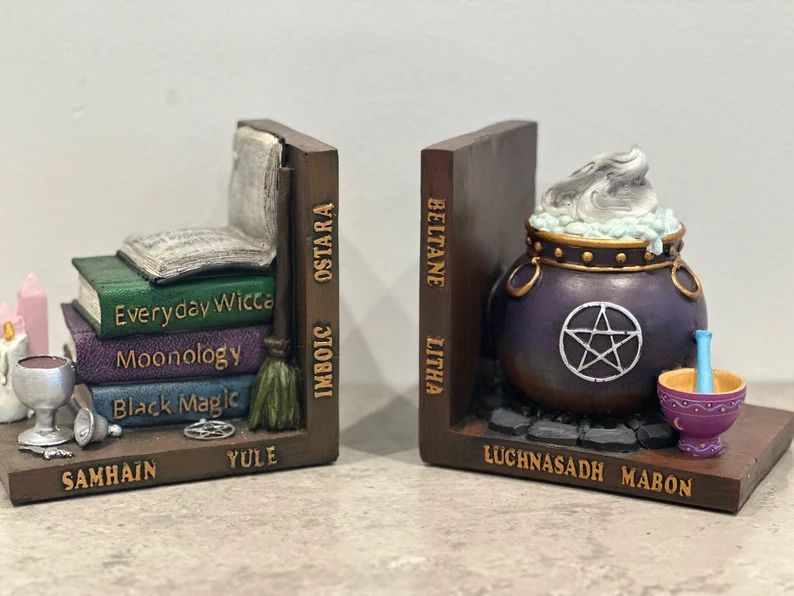 Witchy bookends, with witchy books on one side and a cauldron on the other