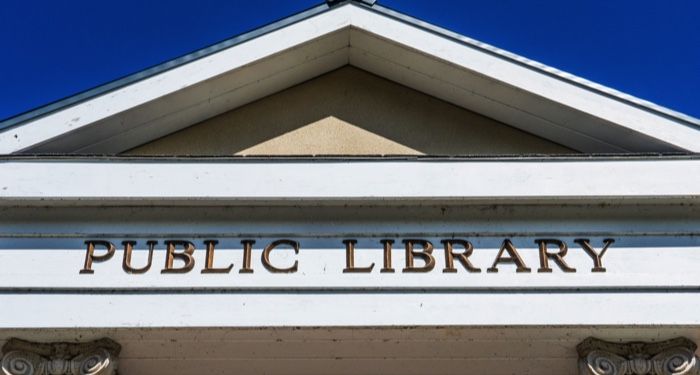 building with the words public library on its facade
