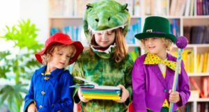 three kids dressed in book character costumes