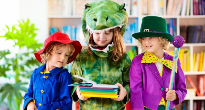 three kids dressed in book character costumes