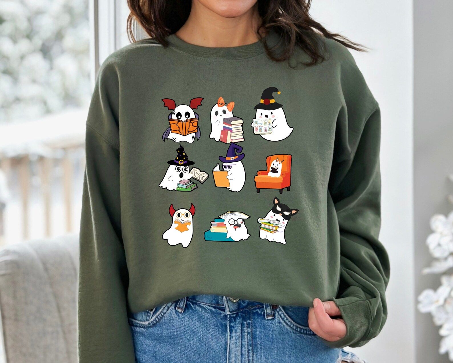 image of a green sweatshirt with ghosts reading books on it. 