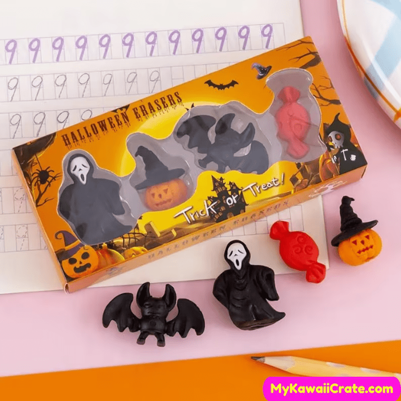Photo of four erasers: a ghost, a pumpkin, a bat and a candy placed on a table.