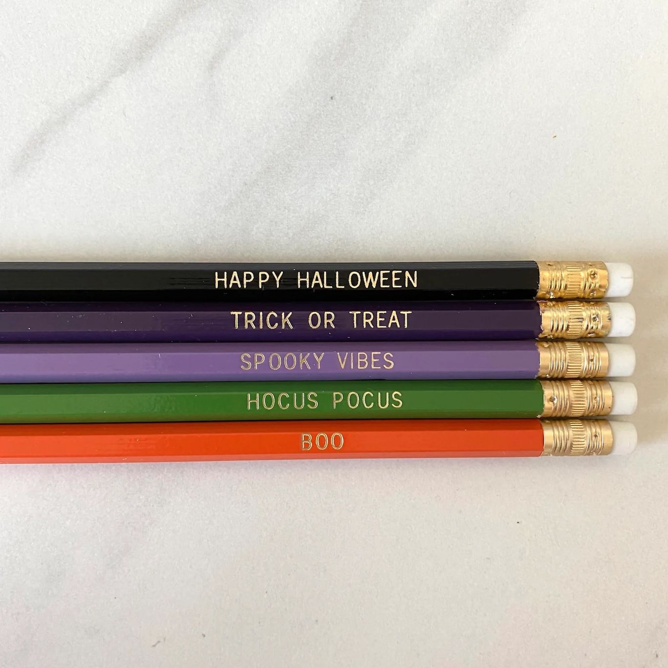 Halloween themed pencils with the embossed phrases: Happy Halloween, Trick or Treat, Spooky Vibes, Hocus Pocus, Boo