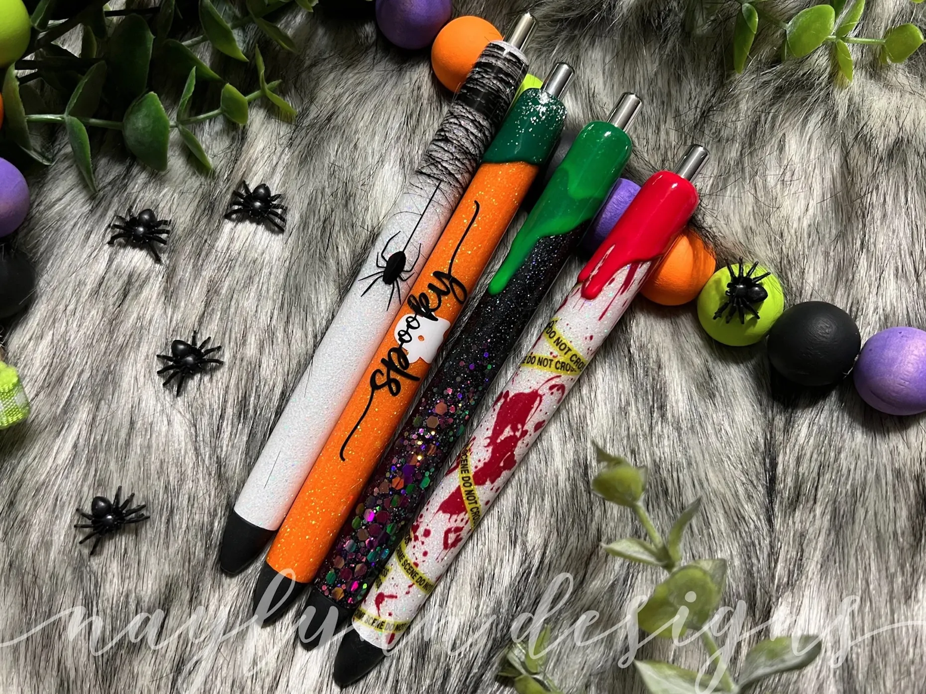 4 pens with glittery Halloween styles