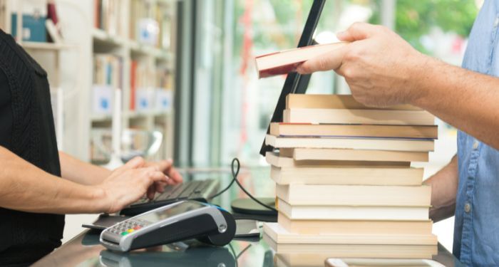 a customer buying books at a cash register