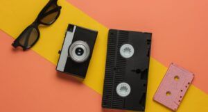 pop culture objects on a colored background, including a VHS tape and a cassette tape
