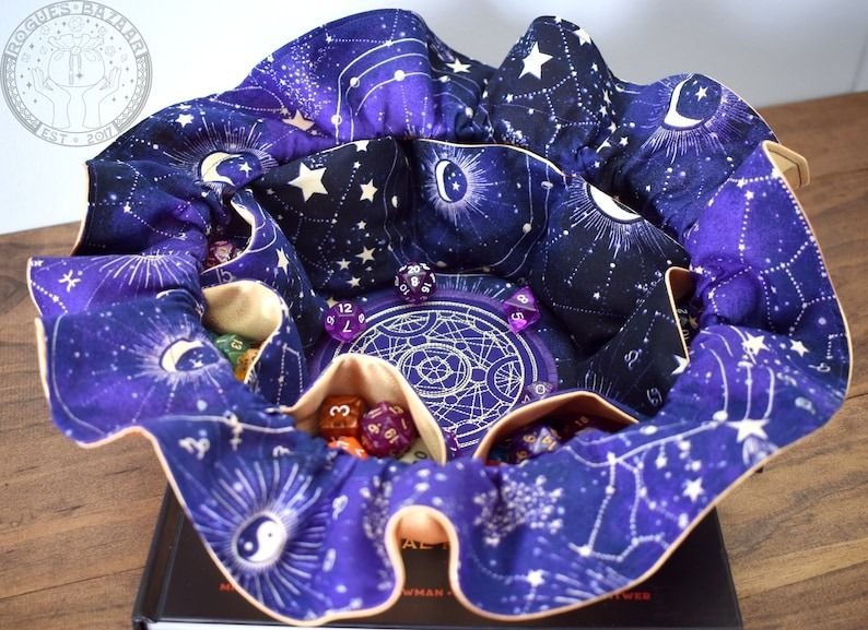 a photo of a dice bag with internal pockets printed in a starry constellation pattern