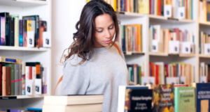 a photo of a woman with light skin browsing at a bookstore
