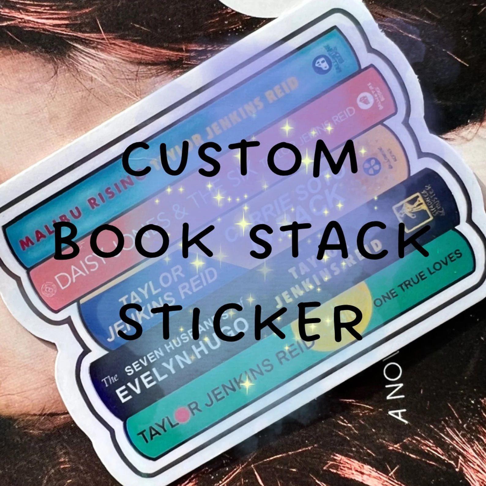 Custom Book Stack Sticker in front of a book cover.