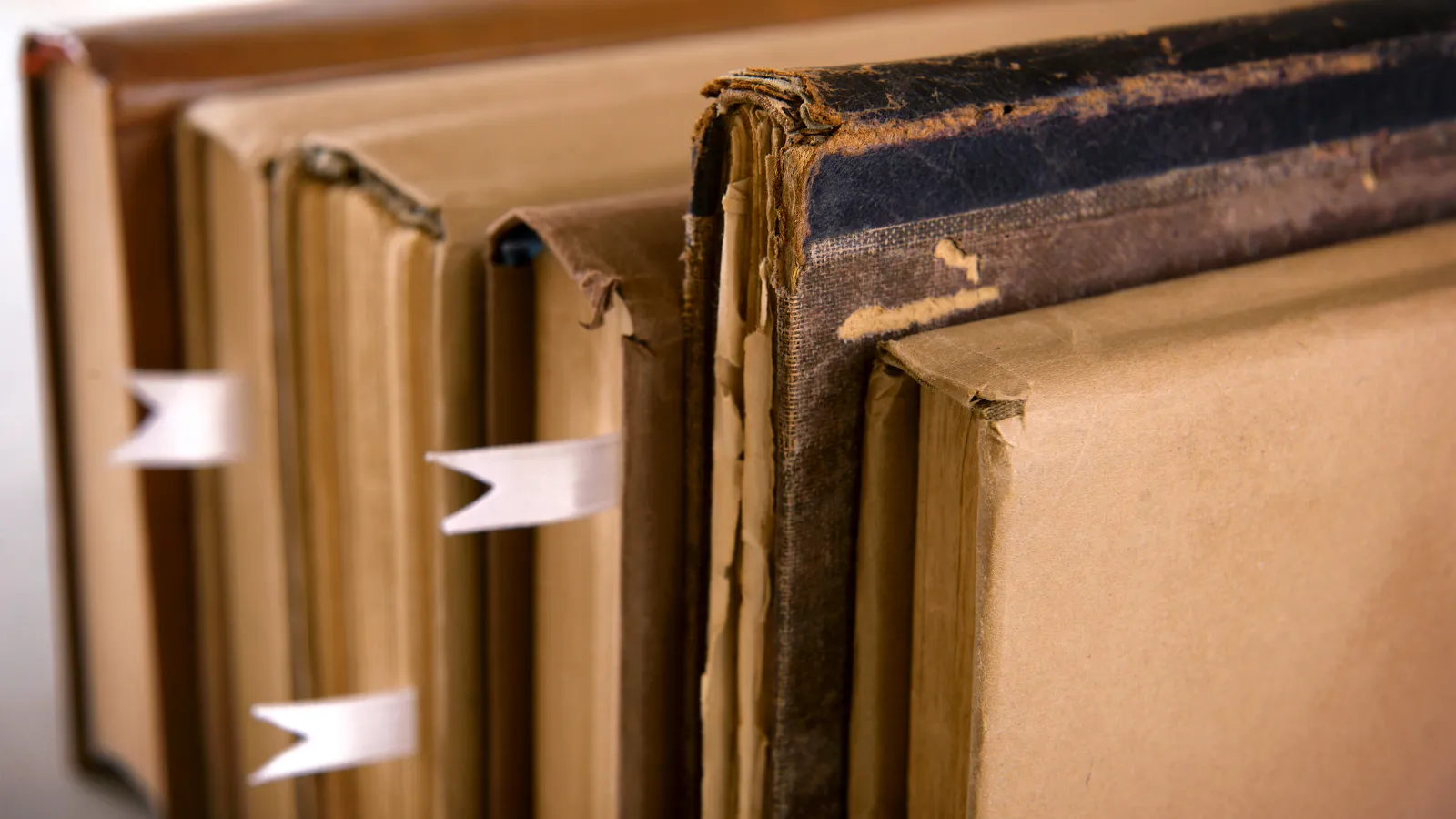 a photo of vintage books with ribbon bookmarks