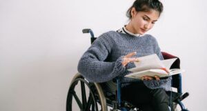 Image of a person reading in a wheelchair