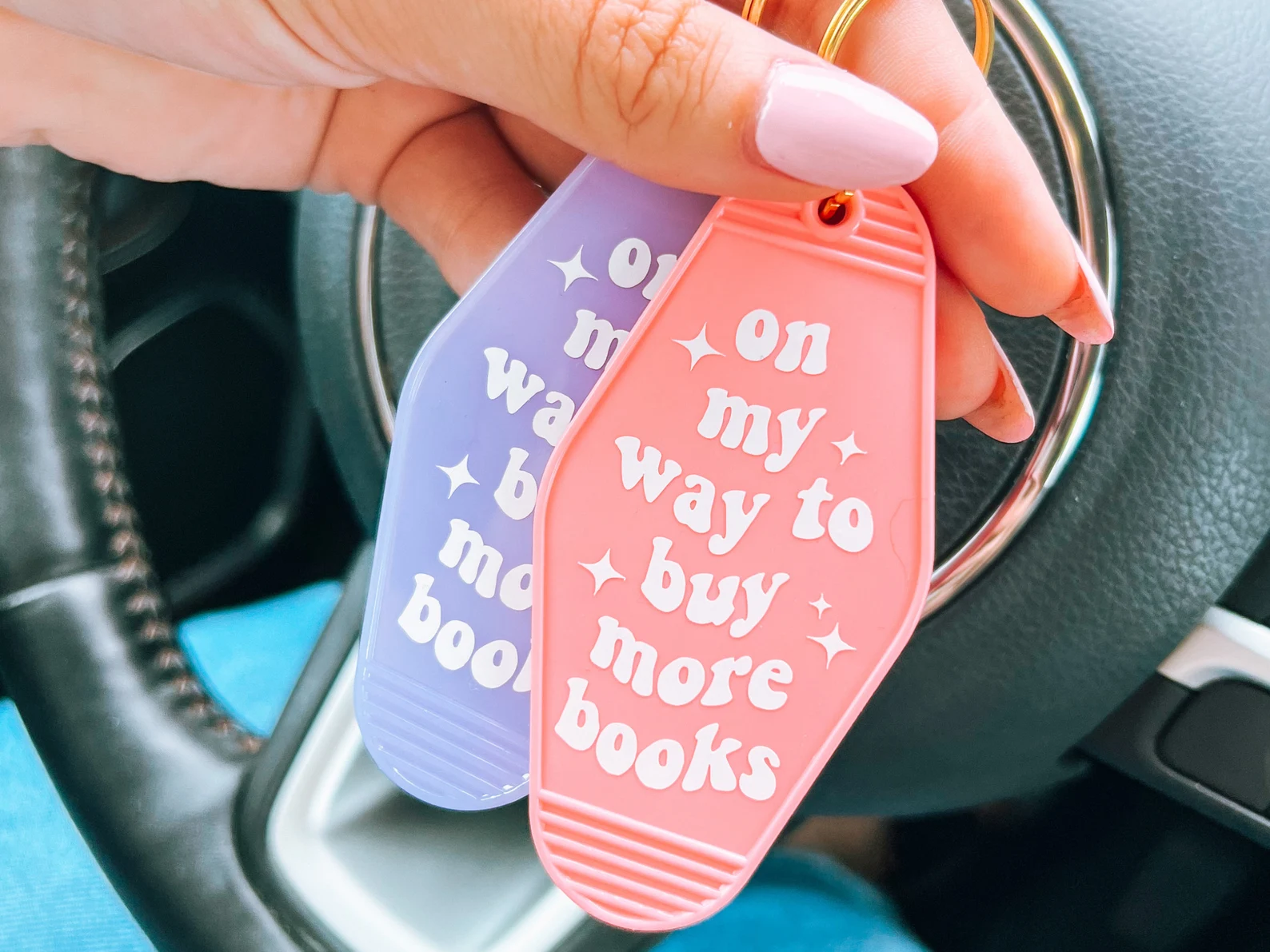 motel style keychain that says 'on my way to buy more books'