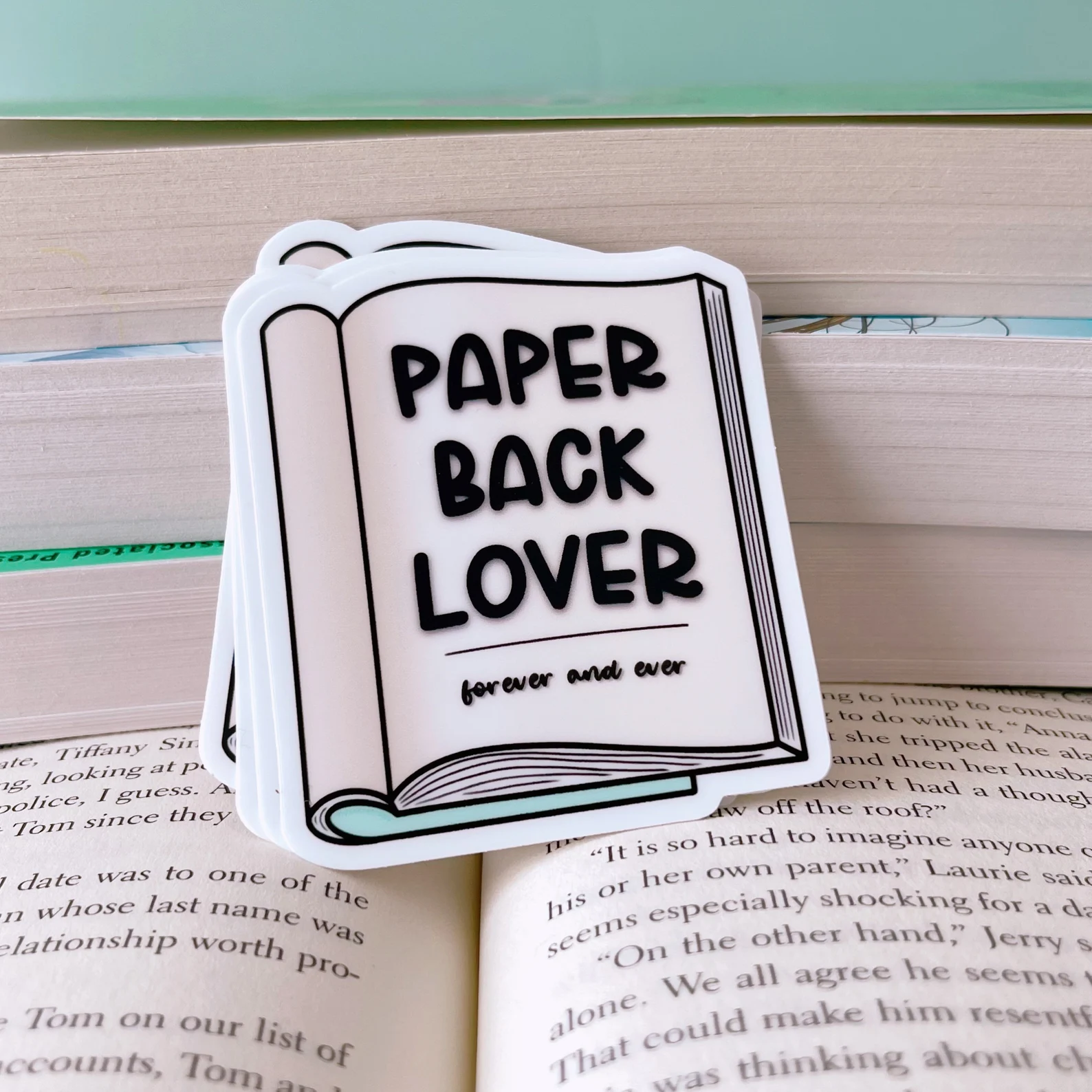 Image of a sticker that says "paperback lover" on a paperbck book.