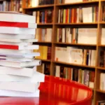 a photo of a stack of books on a table at a bookstore