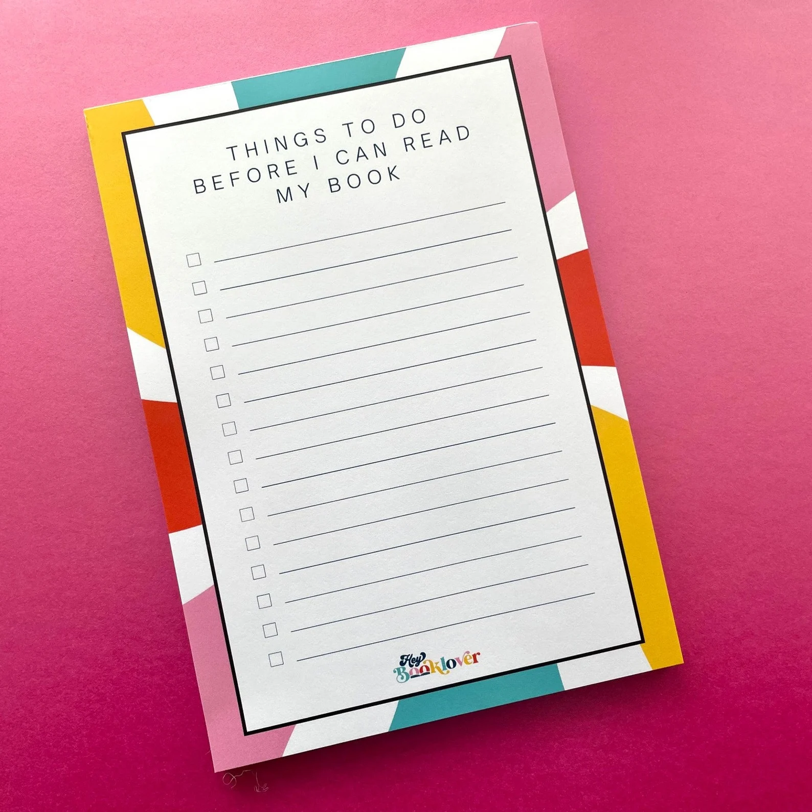 notepad in bright colors that says "things to do before I can read my book"