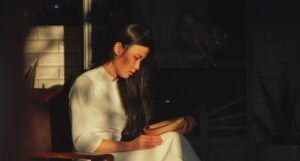 lightly tanned-skin Asian woman reading