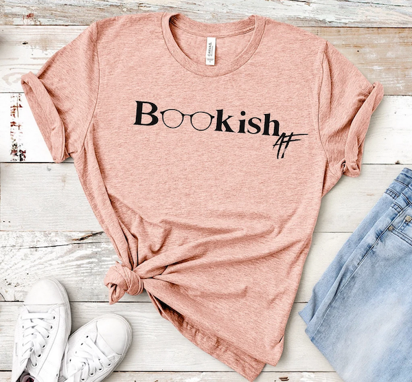 a peach tshirt with black lettering that says "bookish AF"  with the two O letters being reading glasses