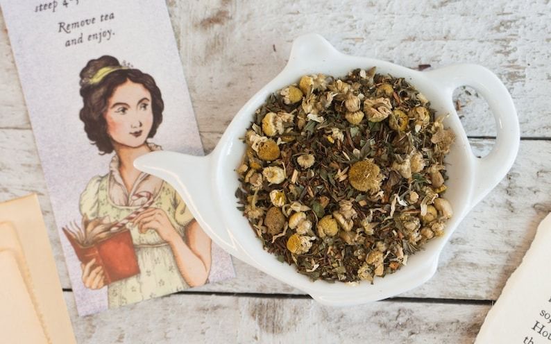 a photo of loose tea in a teapot-shaped bowl with a Pride and Prejudice bookmark