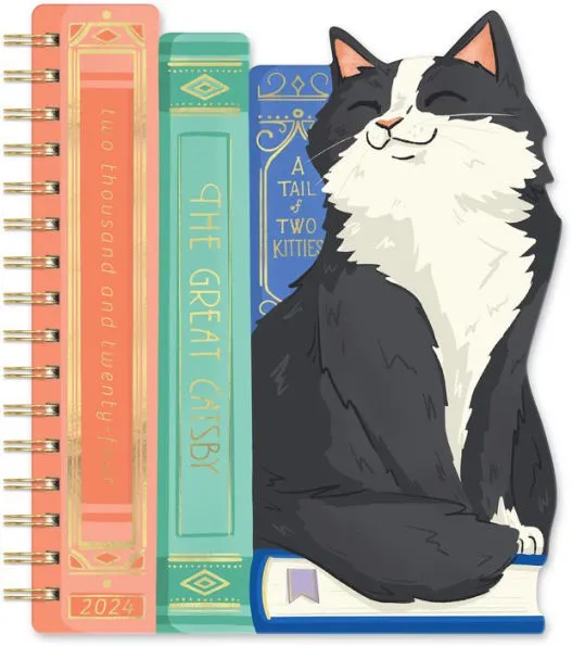 Image of a planner with a cat and stack of books.