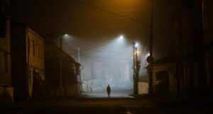 Image of a person wandering a street alone at night