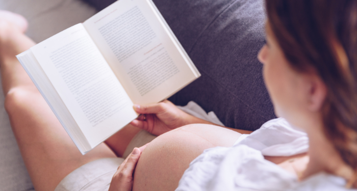 a photo of a pregnant person reading
