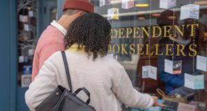 a photo of a couple looking into a bookstore window