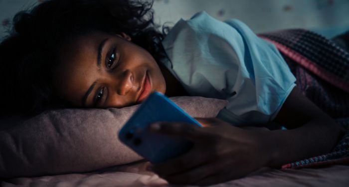 Image of a Black woman on her phone