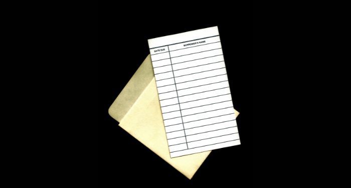 Image of a library checkout card on a black background