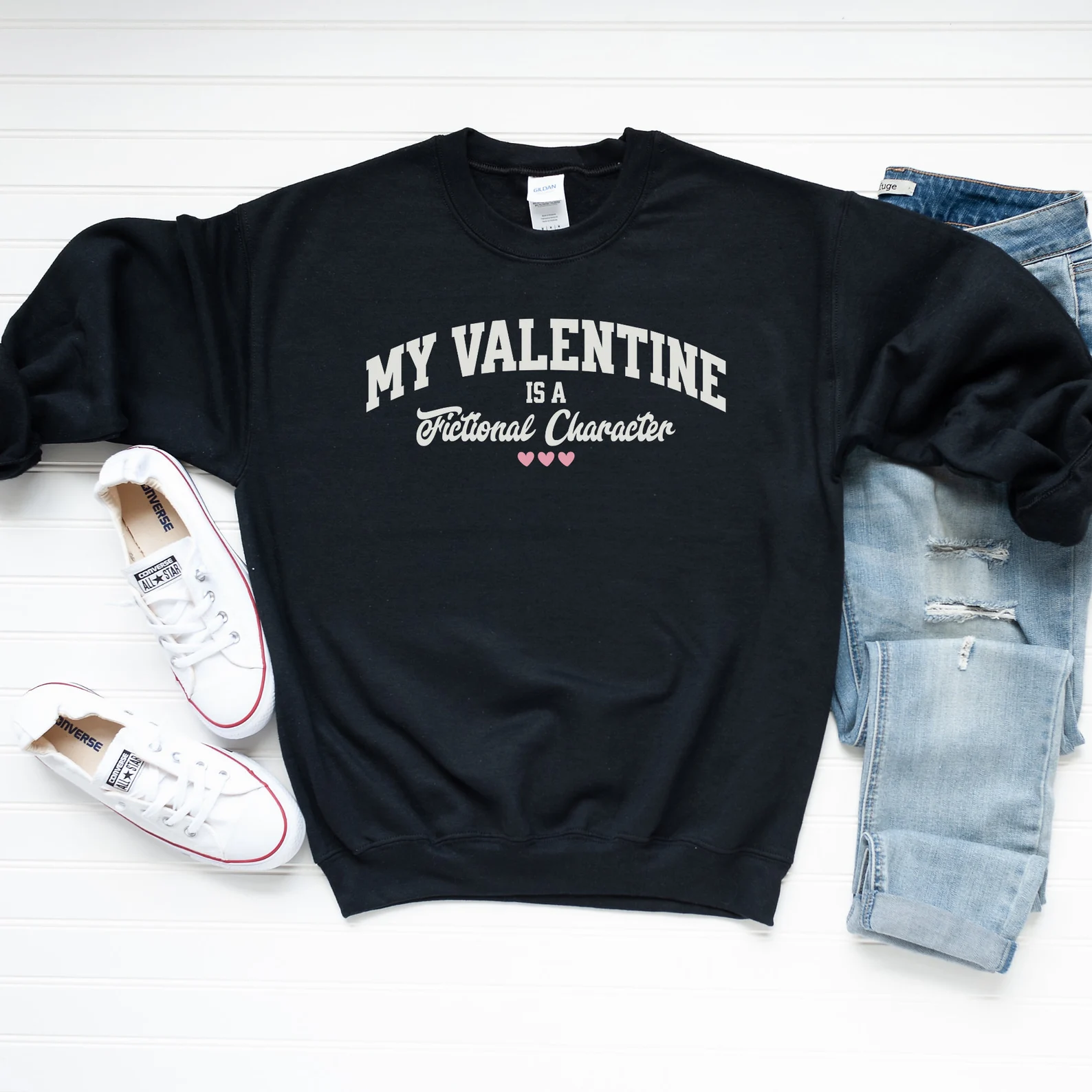 Image of a black sweatshirt that reads "my valentine is a fictional character."