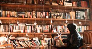 woman in hijab browsing bookstore shelves