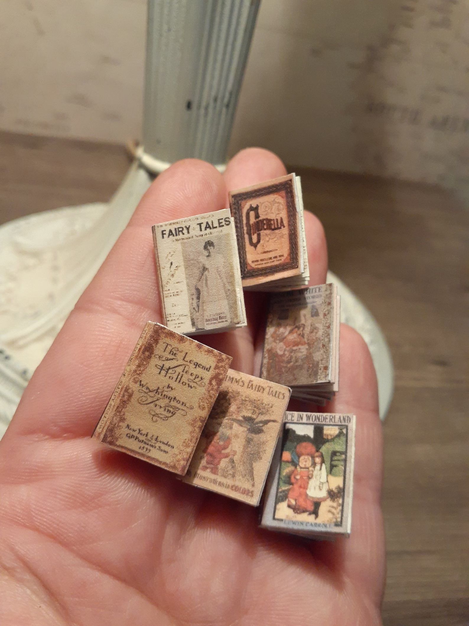 Printable Miniature book Fairy Tales in a hand.