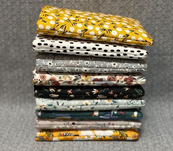 a stack of fabric kindle sleeves in different floral patterns