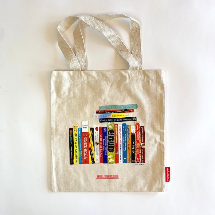 a cream tote bag with the spines of several novels by Latinx authors on it 
