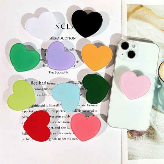 several different colors of heart shaped pop sockets 