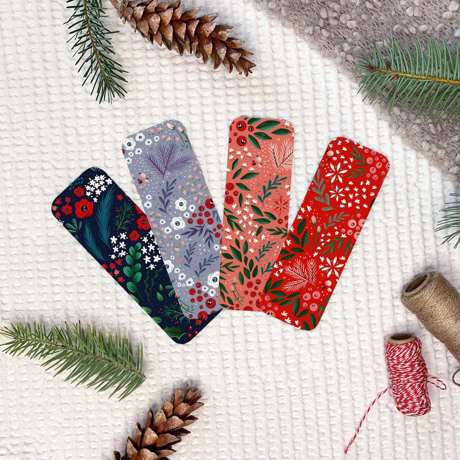 A set of four bookmarks depicting winter florals, berries, and branches