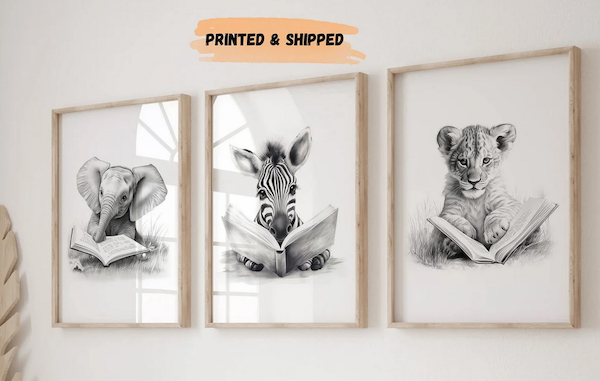 3 framed black and white sketches of an elephant, zebra, and lion cub reading a book