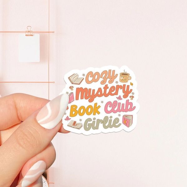 sticker of text in yellow, green, red, and pink text that reads "cozy mystery book club girlie"