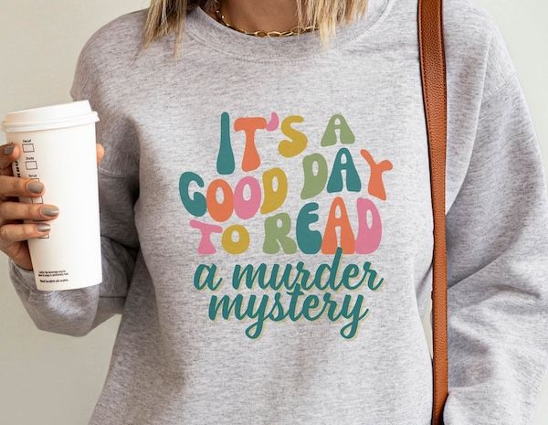 light grey crewneck sweater with text that reads "it's a good day to read a murder mystery"