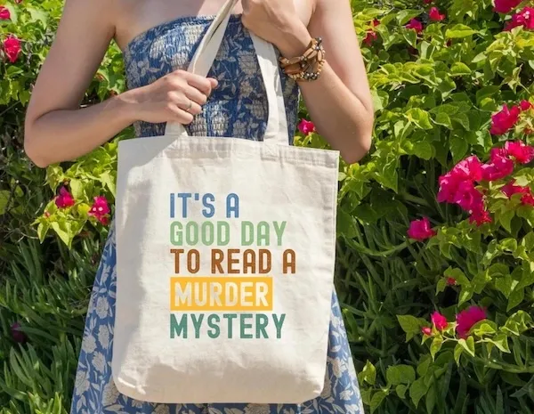 light grey crewneck sweater with text that reads "it's a good day to read a murder mystery"