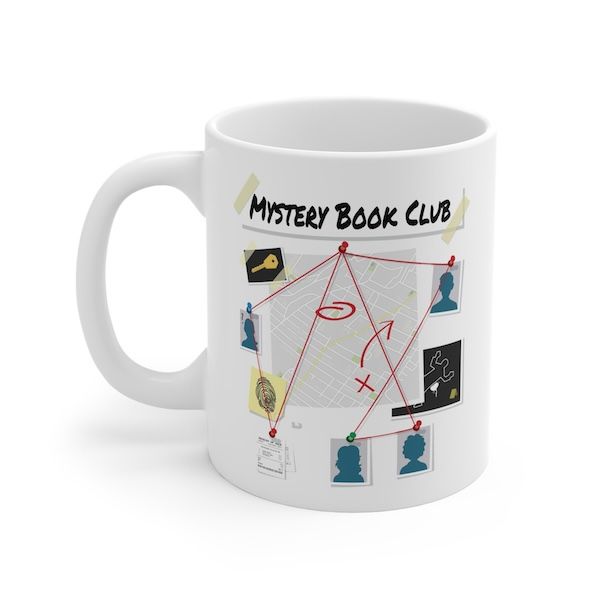 a white coffee mug with black text that reads "Mystery Book Club"