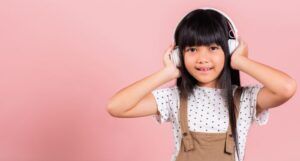 Image of an Asian child with white headphones