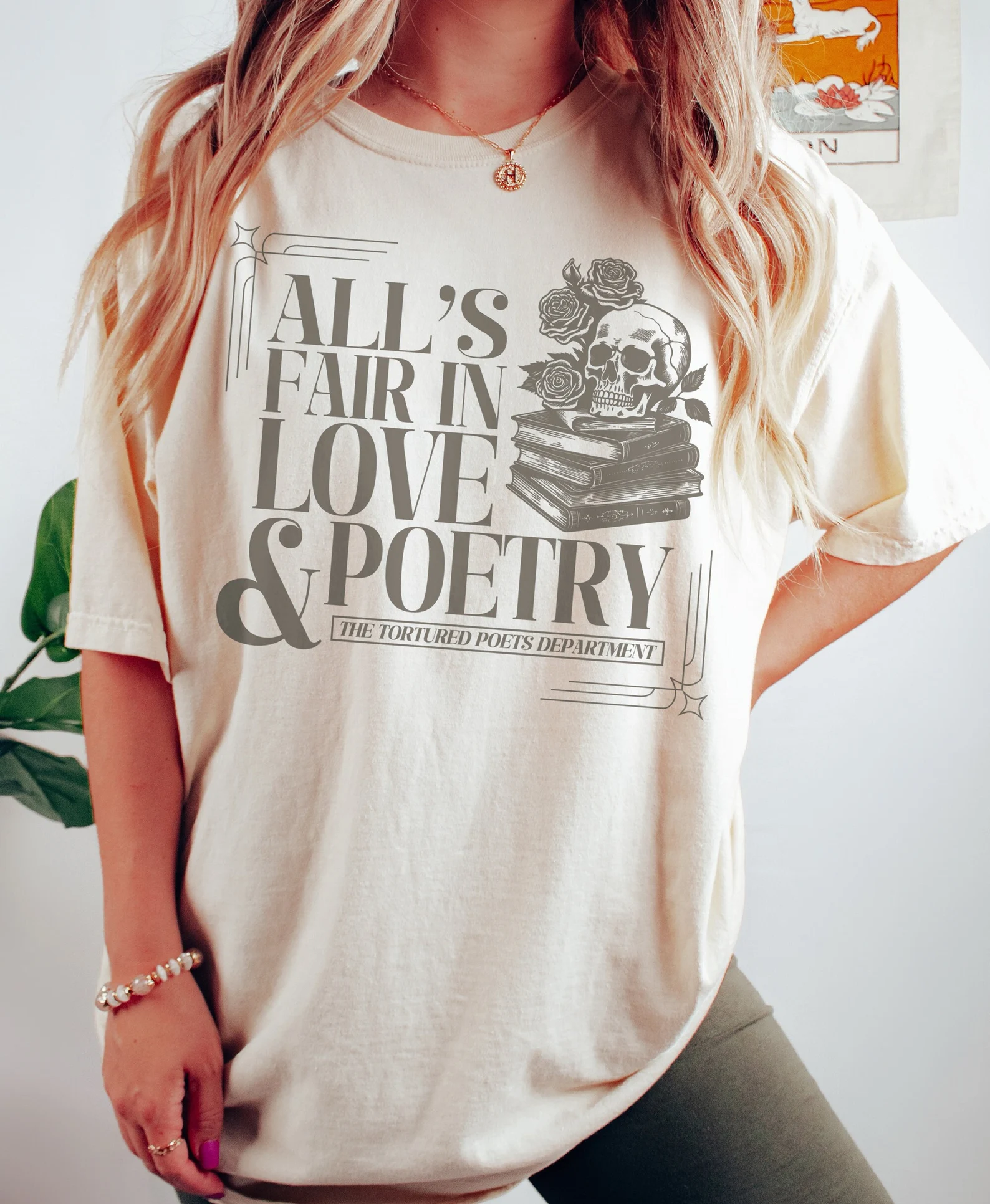 Cream color t-shirt that says "All's fair in love & poetry: The Tortured Poets Department."