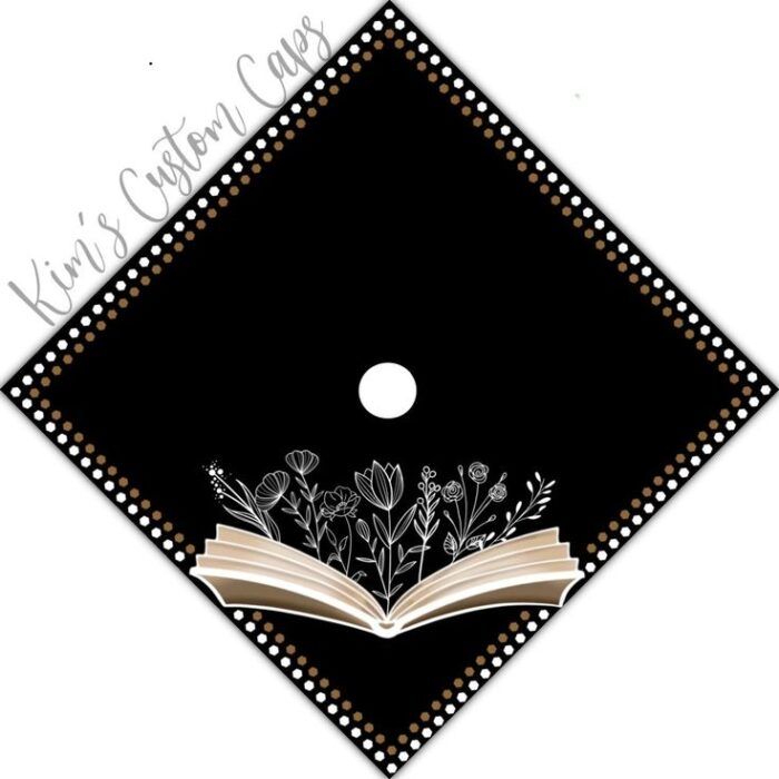 a black diamond-shaped graduation cap topper decorated with flowers growing out of an open book