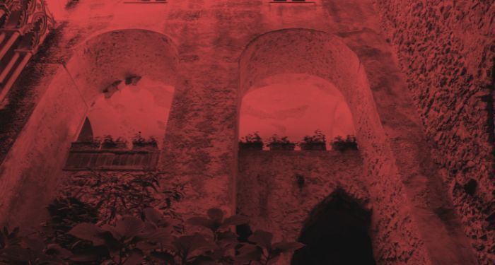 stone facade of Italian villa with a red filter applied