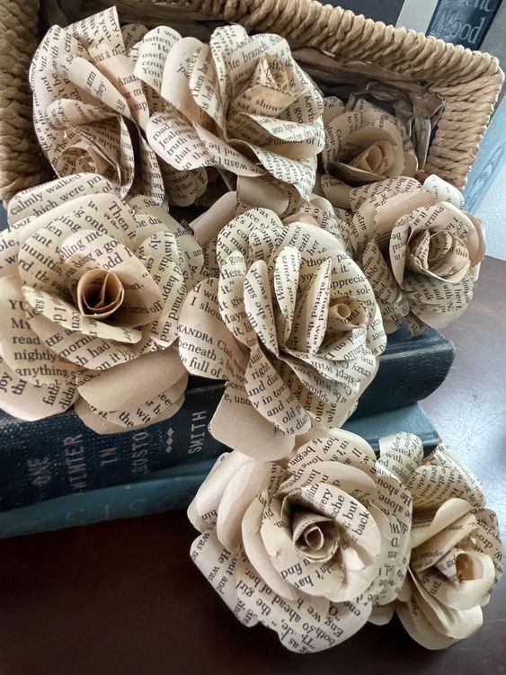 several roses designed from cream colored book pages with black text 