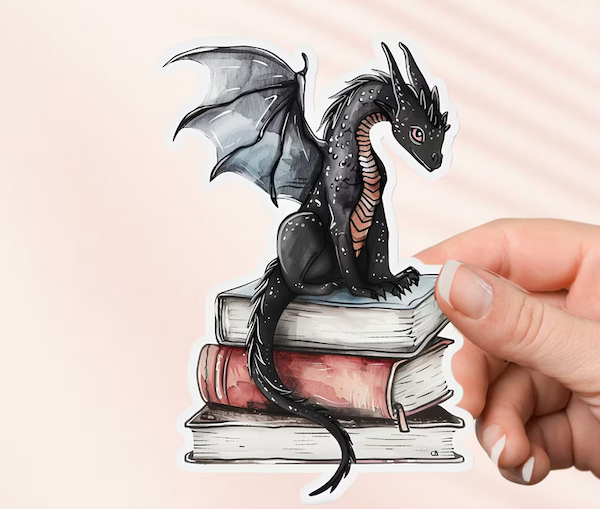 sticker of an illustrated dragon with wing open sitting on books